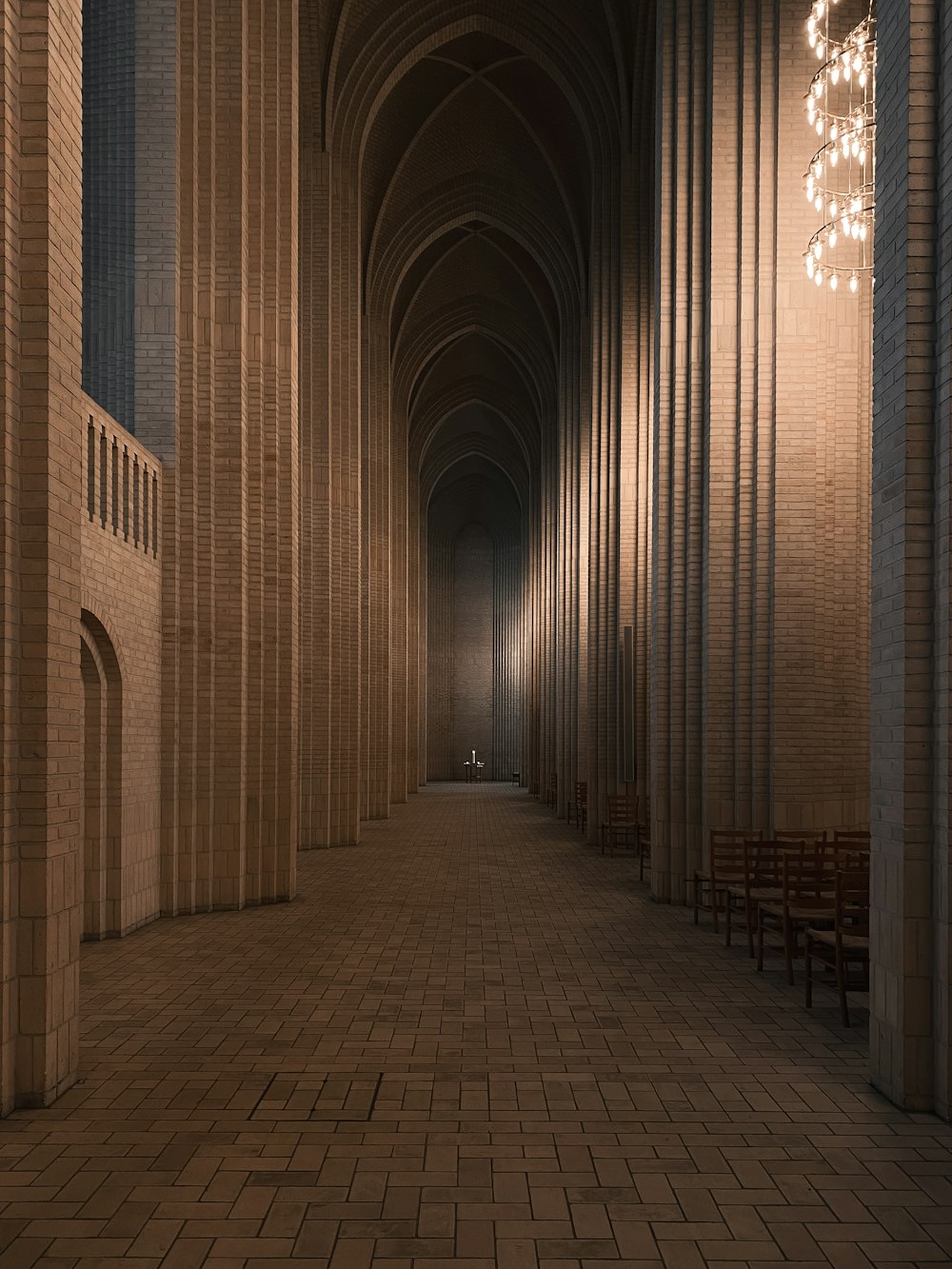 a long hallway with a chandelier hanging from the ceiling