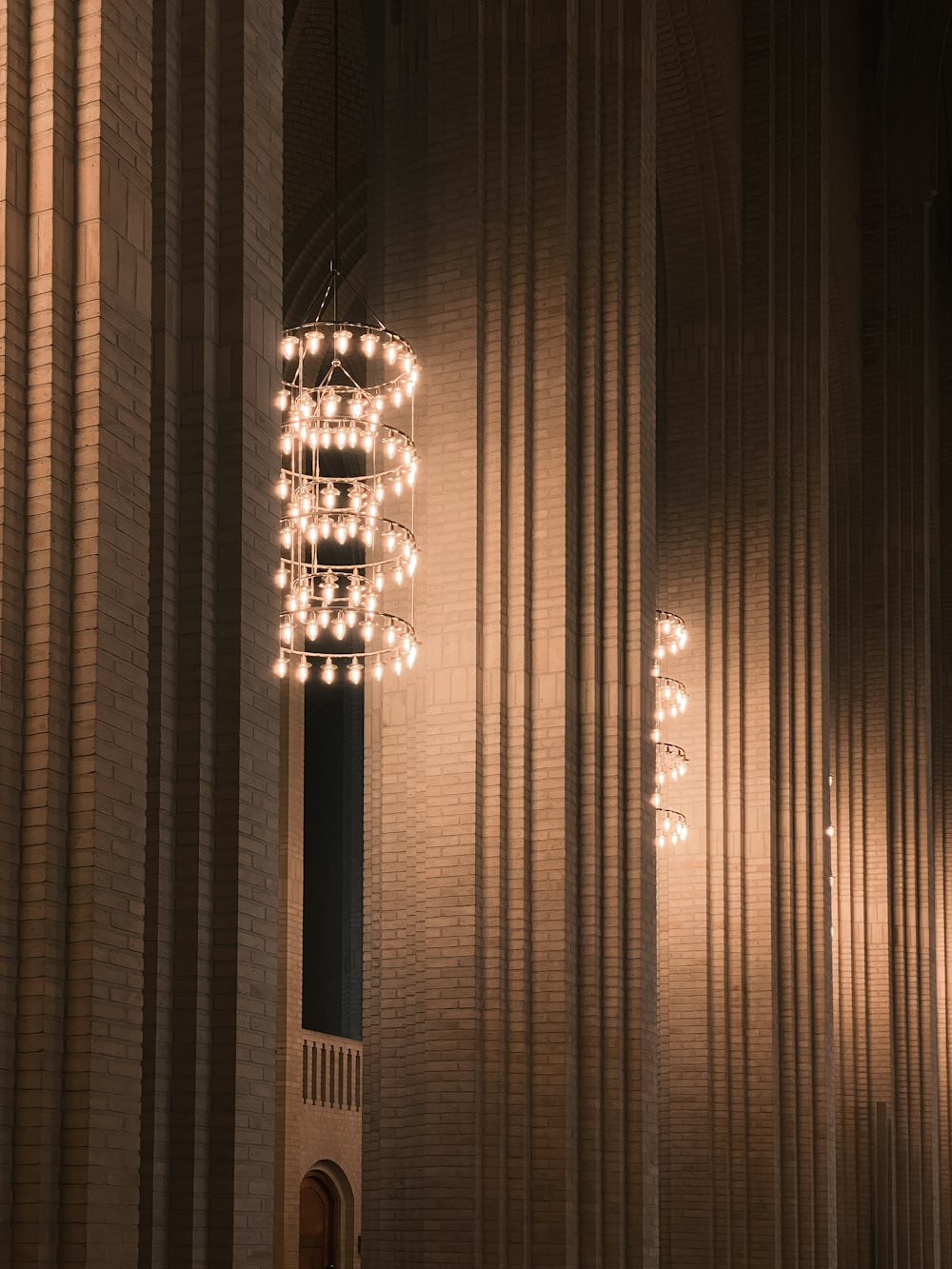 a room with a large light fixture hanging from the ceiling