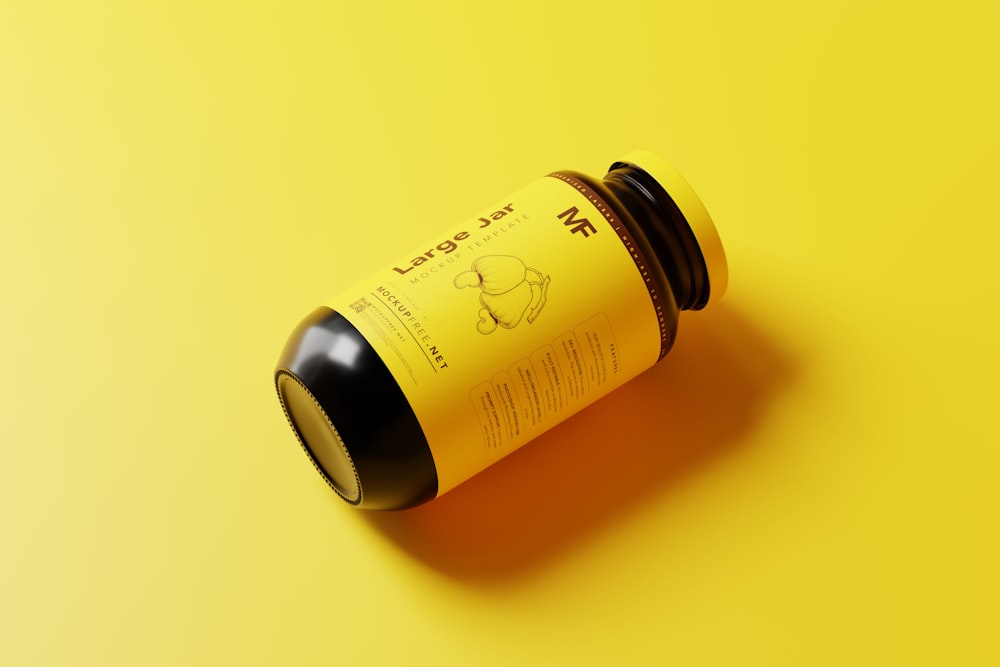 a bottle of liquid sitting on top of a yellow surface