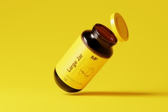 a bottle of mustard sitting on top of a yellow surface