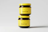 two jars of small jar jam sitting on top of each other