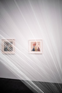a white room with two pictures on the wall