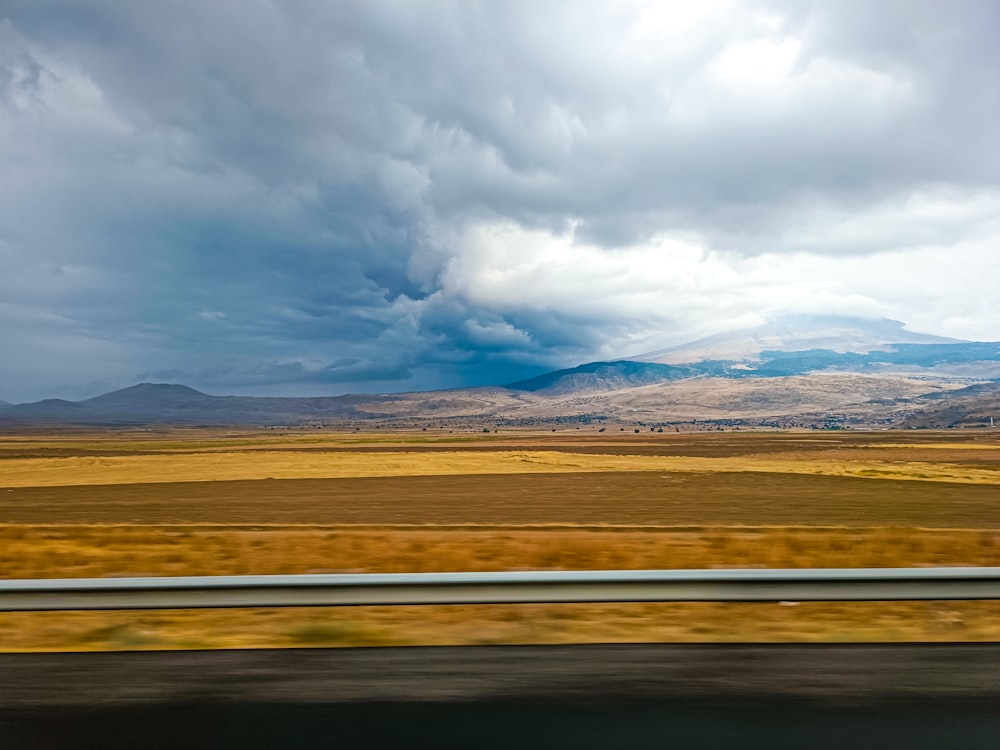 a view of a field with mountains in the distance