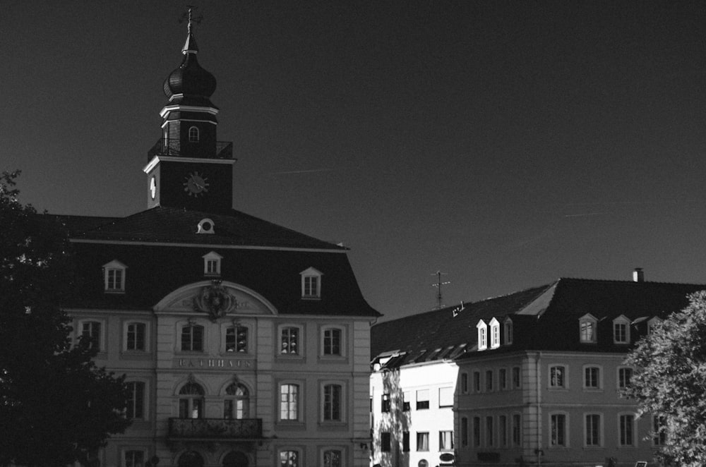 a black and white photo of a building with a clock tower