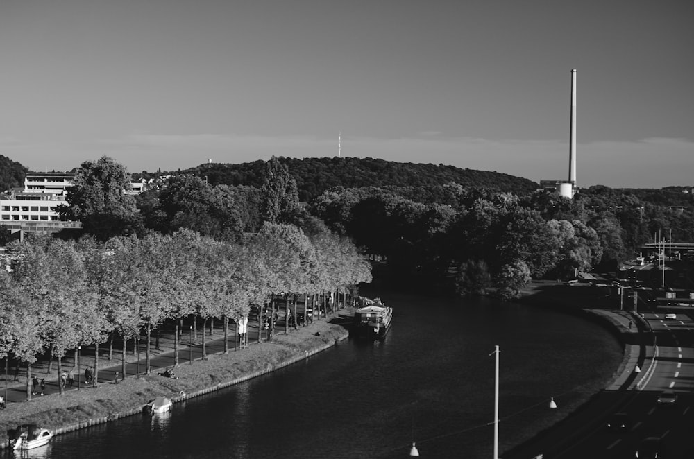 a black and white photo of a river running through a city