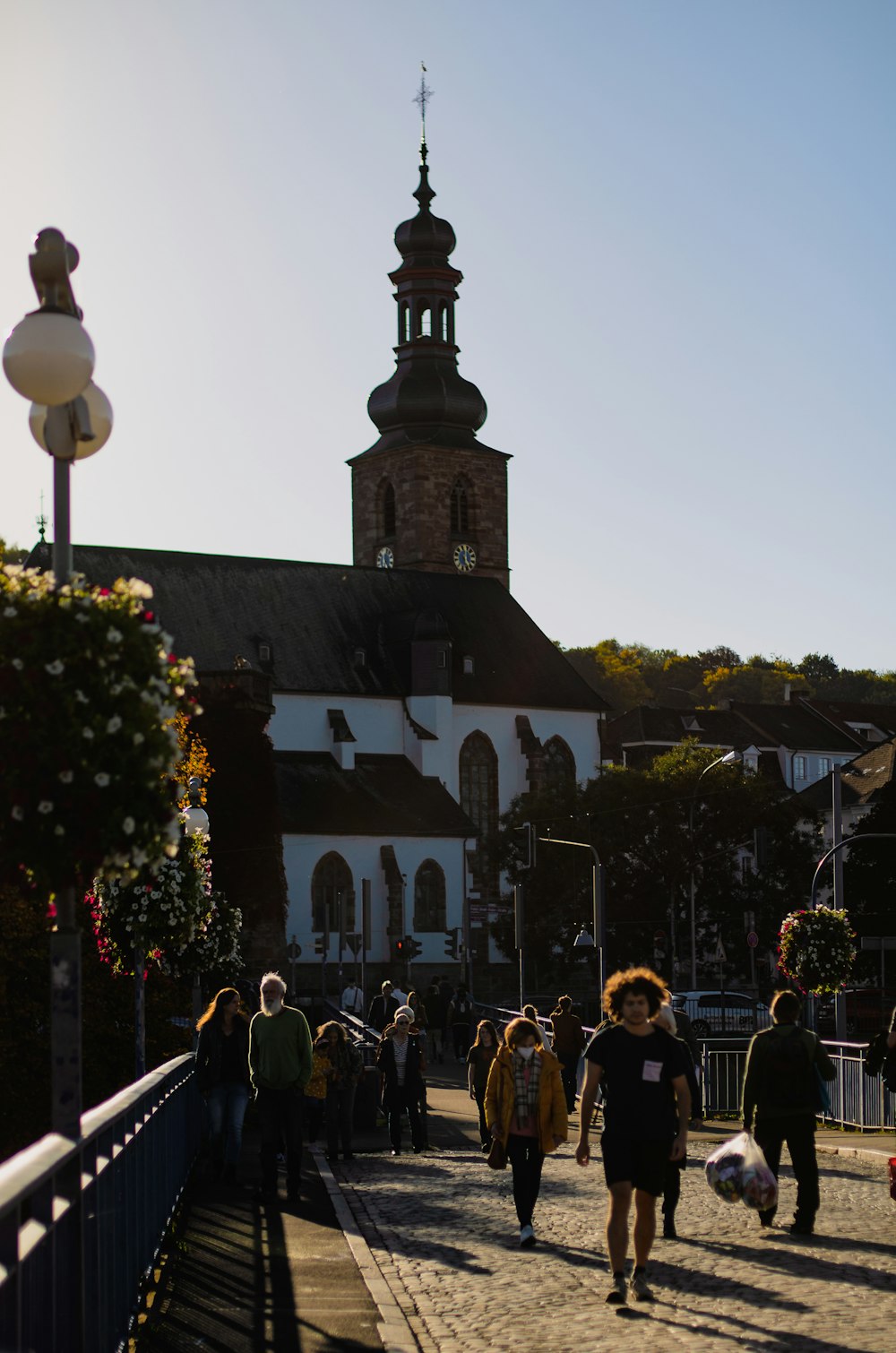 a group of people walking across a bridge