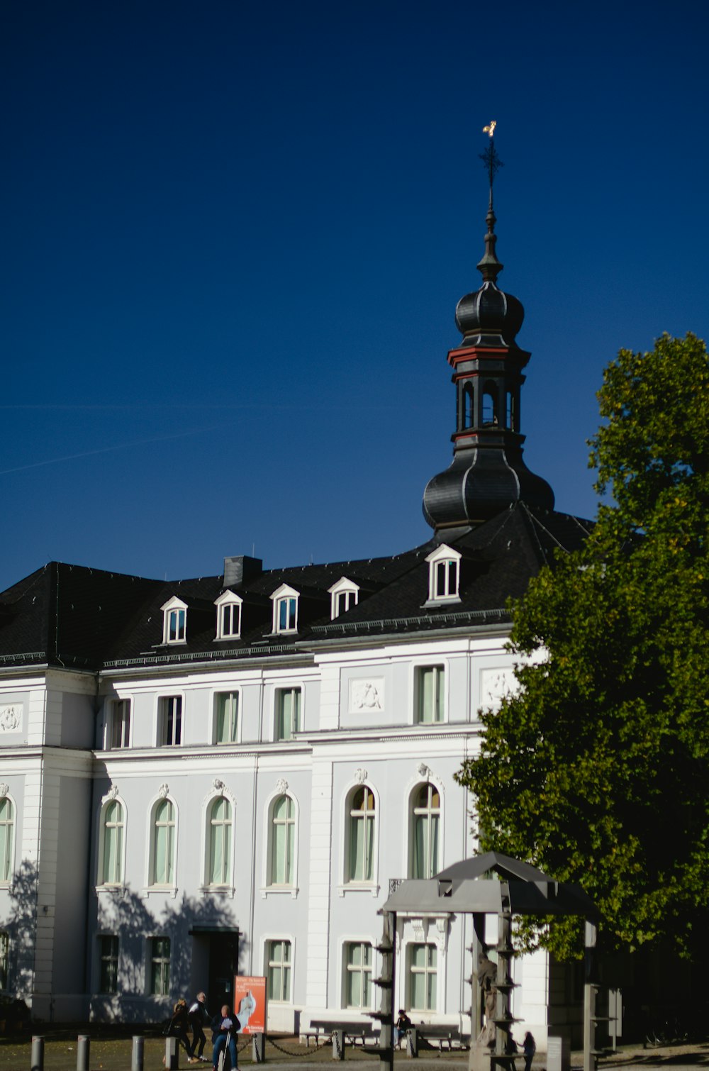 a large white building with a clock tower