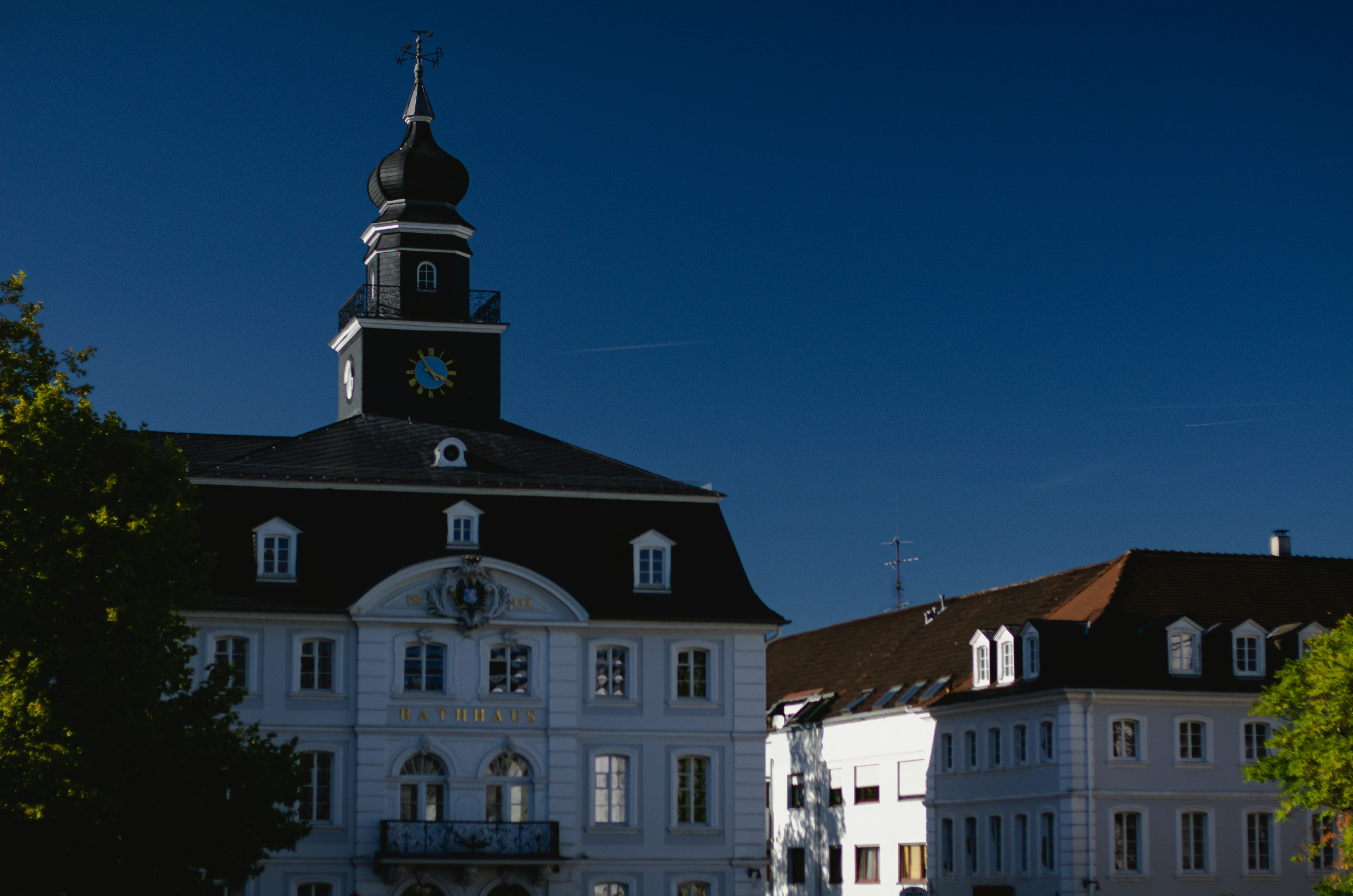 a large white building with a clock tower