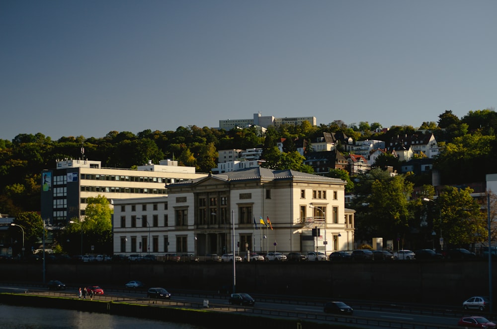 a large white building sitting on the side of a river