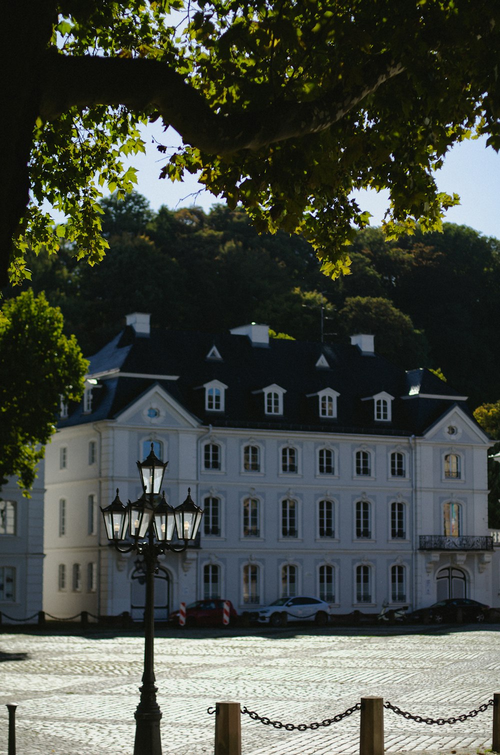 a large white building with a clock on the front of it