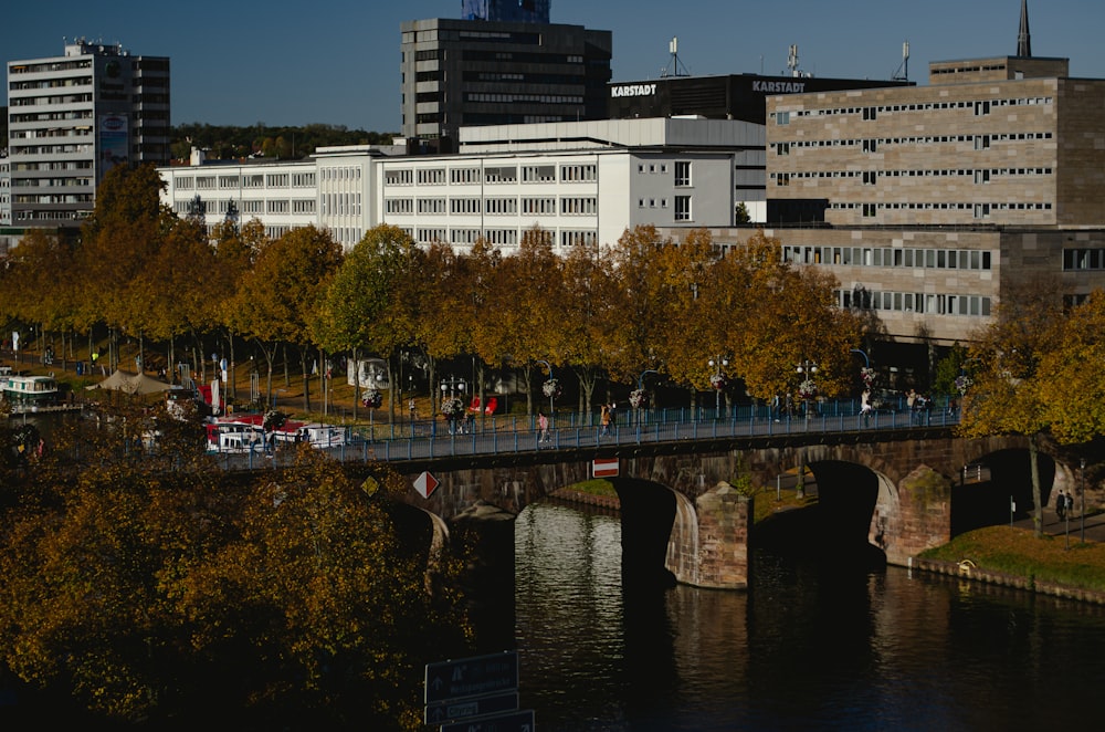 a bridge over a body of water with buildings in the background