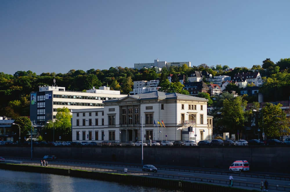 a large white building sitting on the side of a river