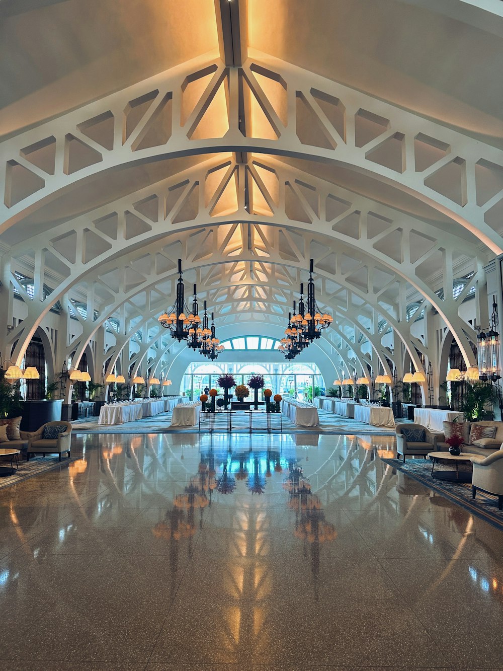 a large lobby with chandeliers and couches