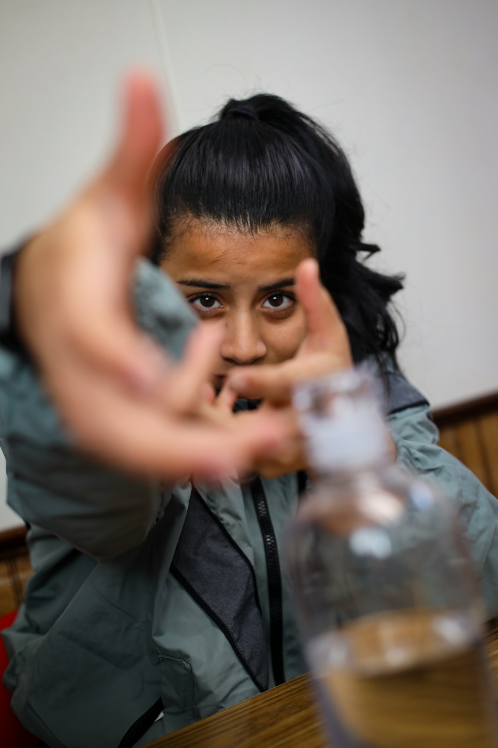 a woman sitting at a table with a glass of wine