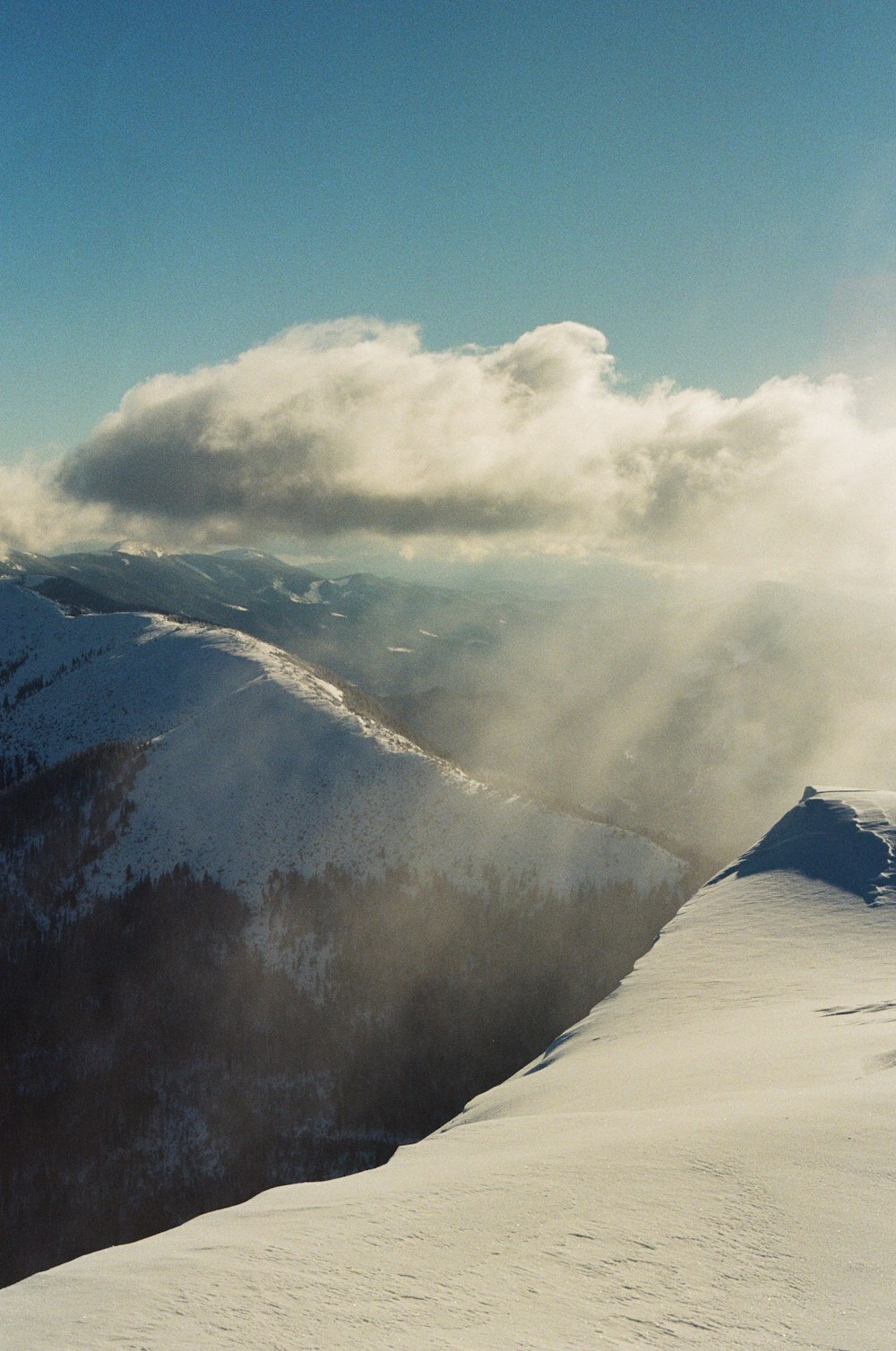 a person riding skis on top of a snow covered slope