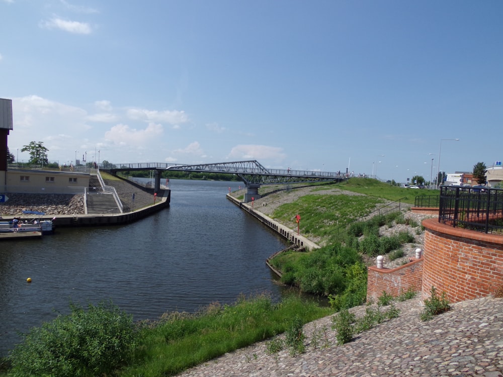 a view of a river with a bridge in the background