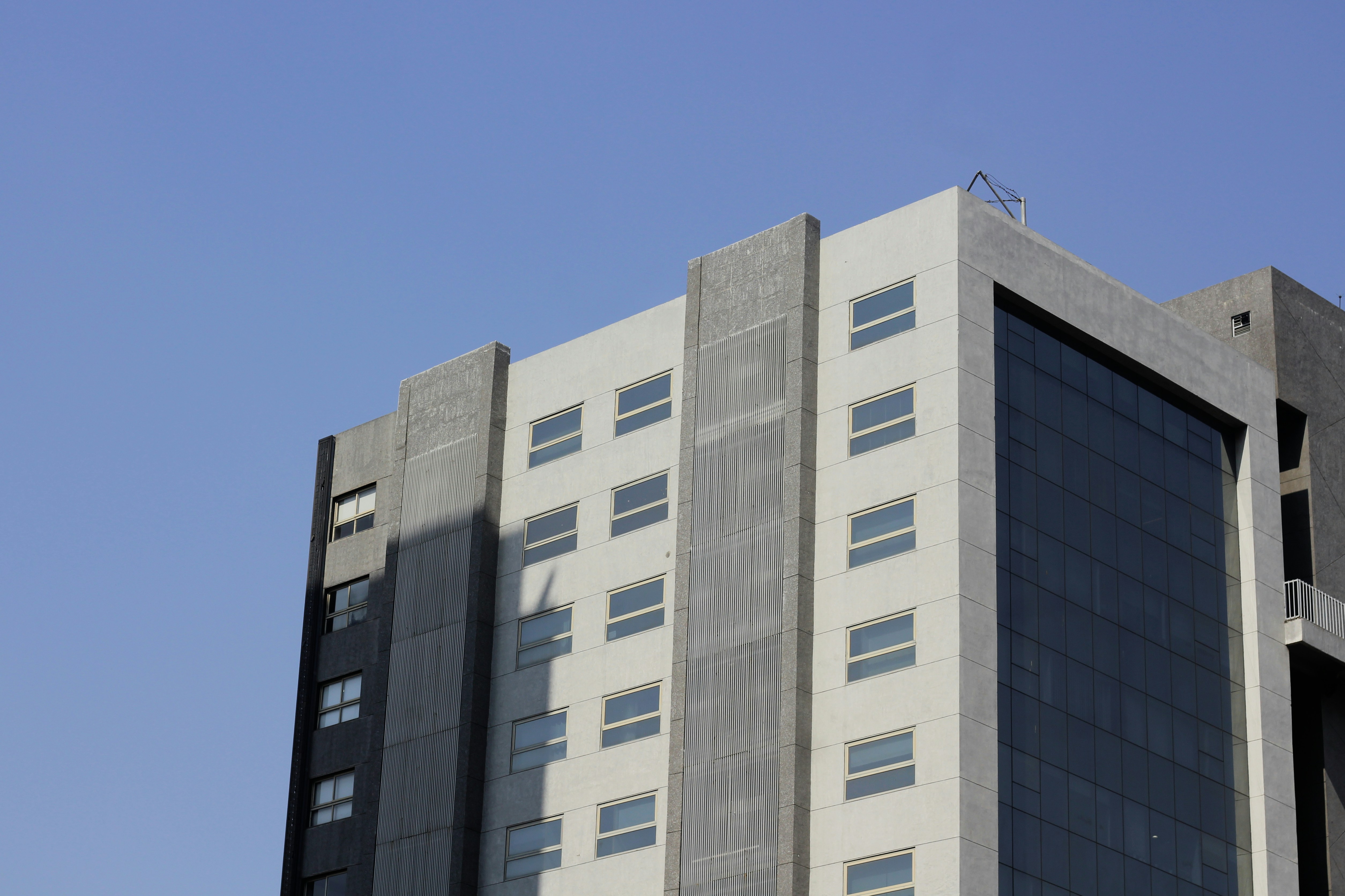 Modern office building facade with glass and concrete in bright daylight