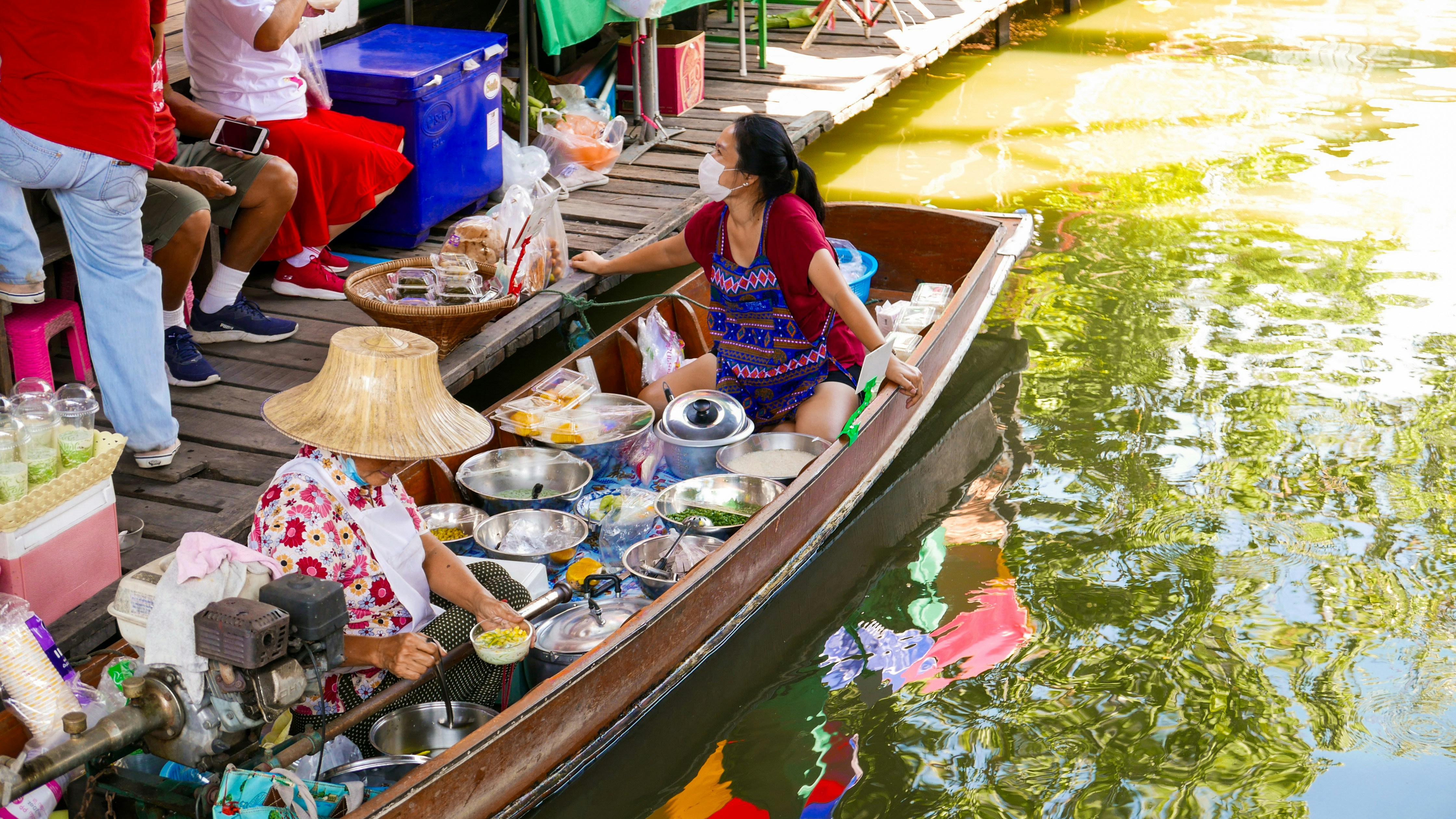 a group of people sitting on a boat in a body of water