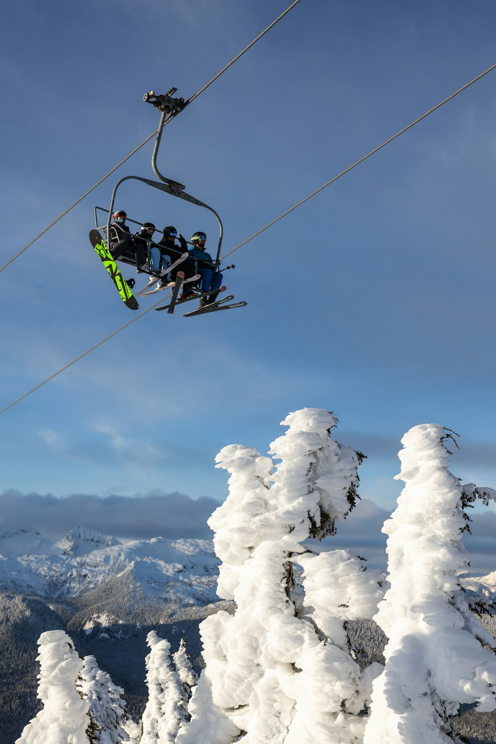 a group of people riding skis down a snow covered slope