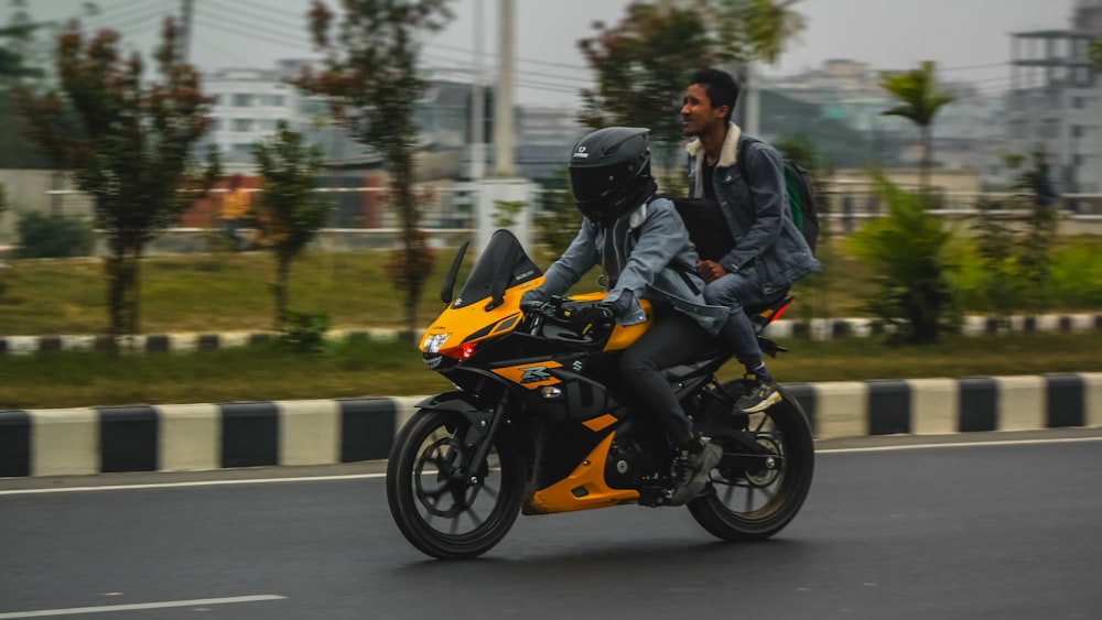 a man and a woman riding a yellow motorcycle