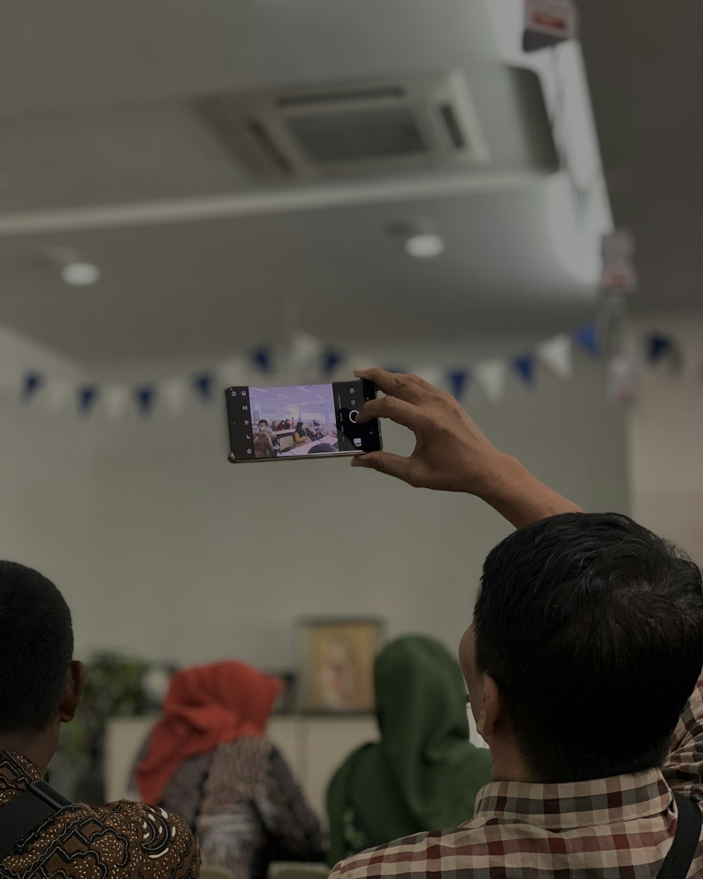 a man taking a picture with his cell phone