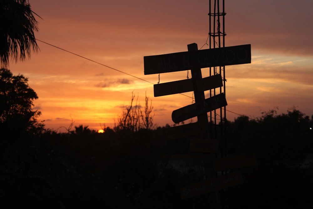 a street sign in front of a sunset