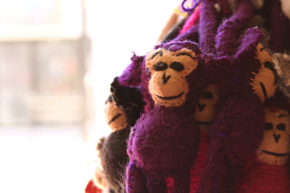 a group of stuffed animals hanging from a wall