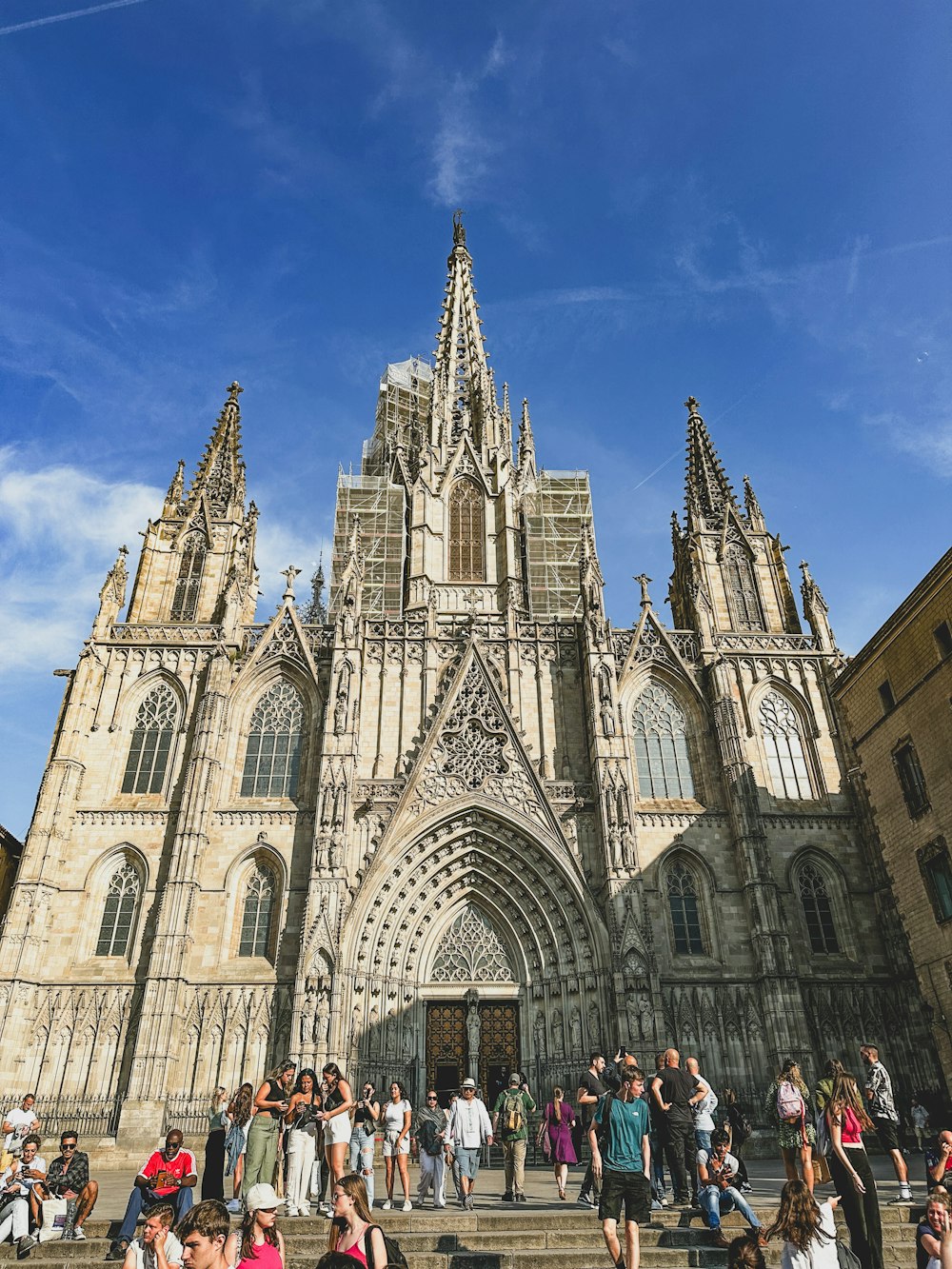 a group of people standing in front of a large cathedral