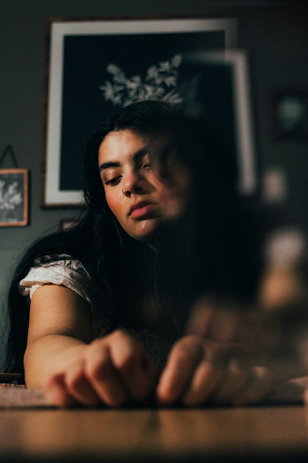 a woman sitting at a table with her eyes closed