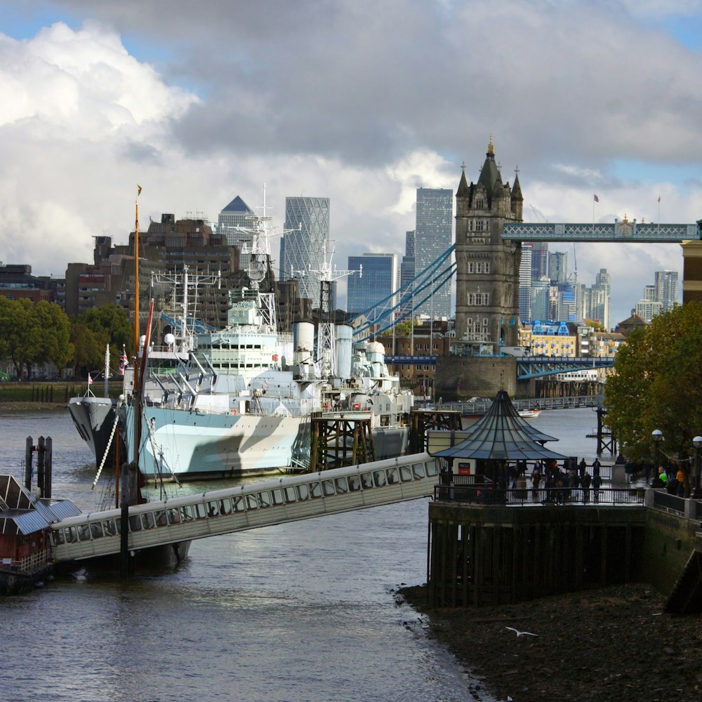 a boat is docked in the water near a bridge