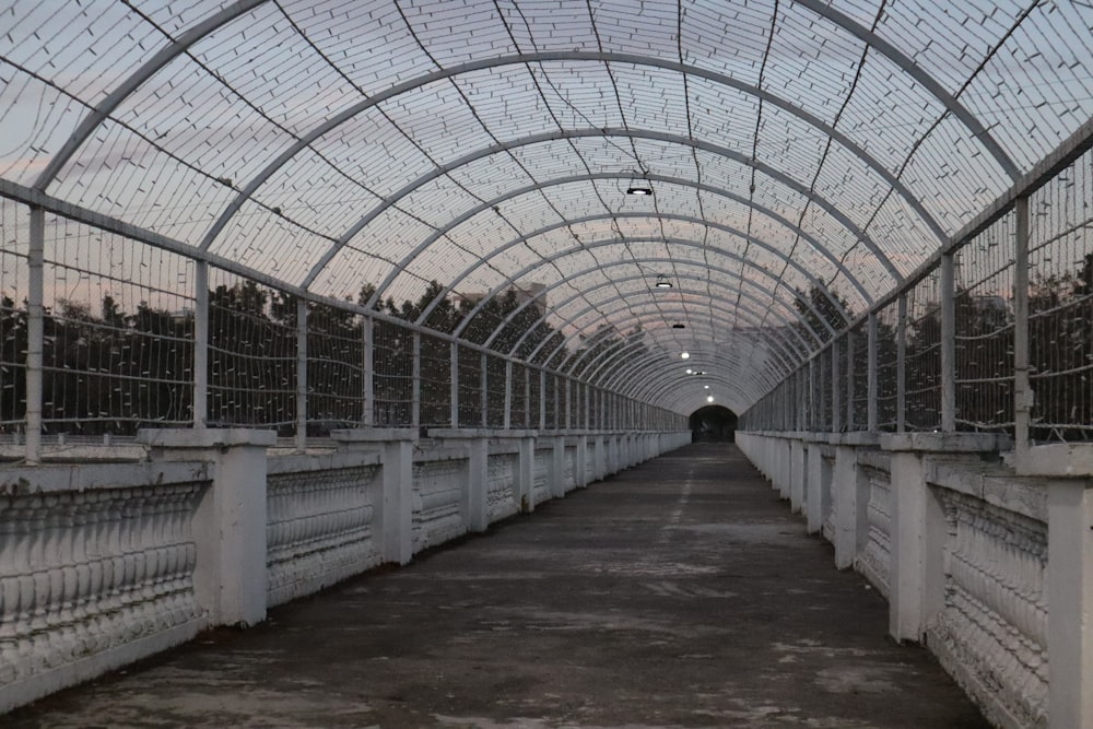 a long walkway with a large metal structure over it