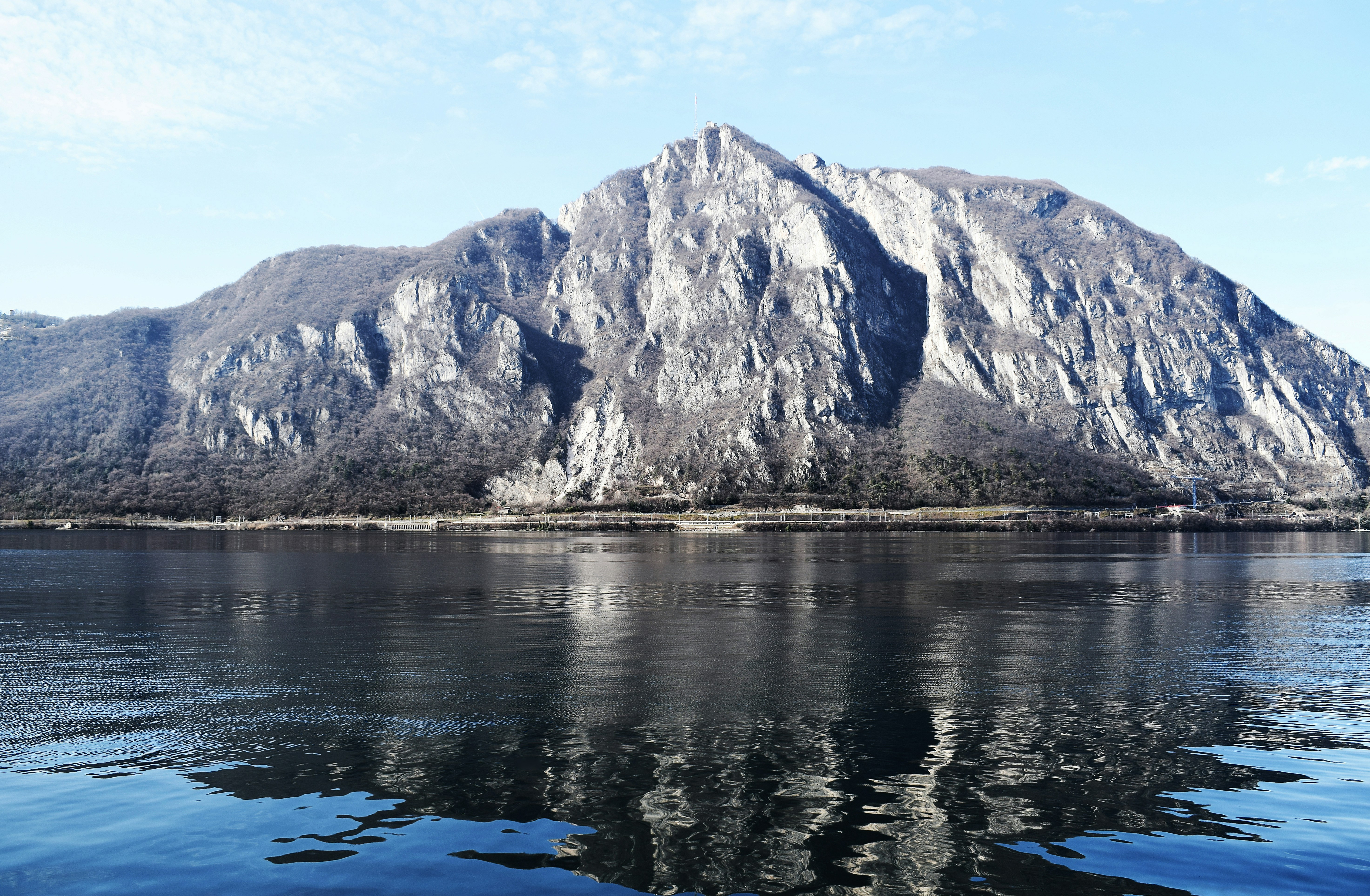 a mountain is reflected in the still water of a lake
