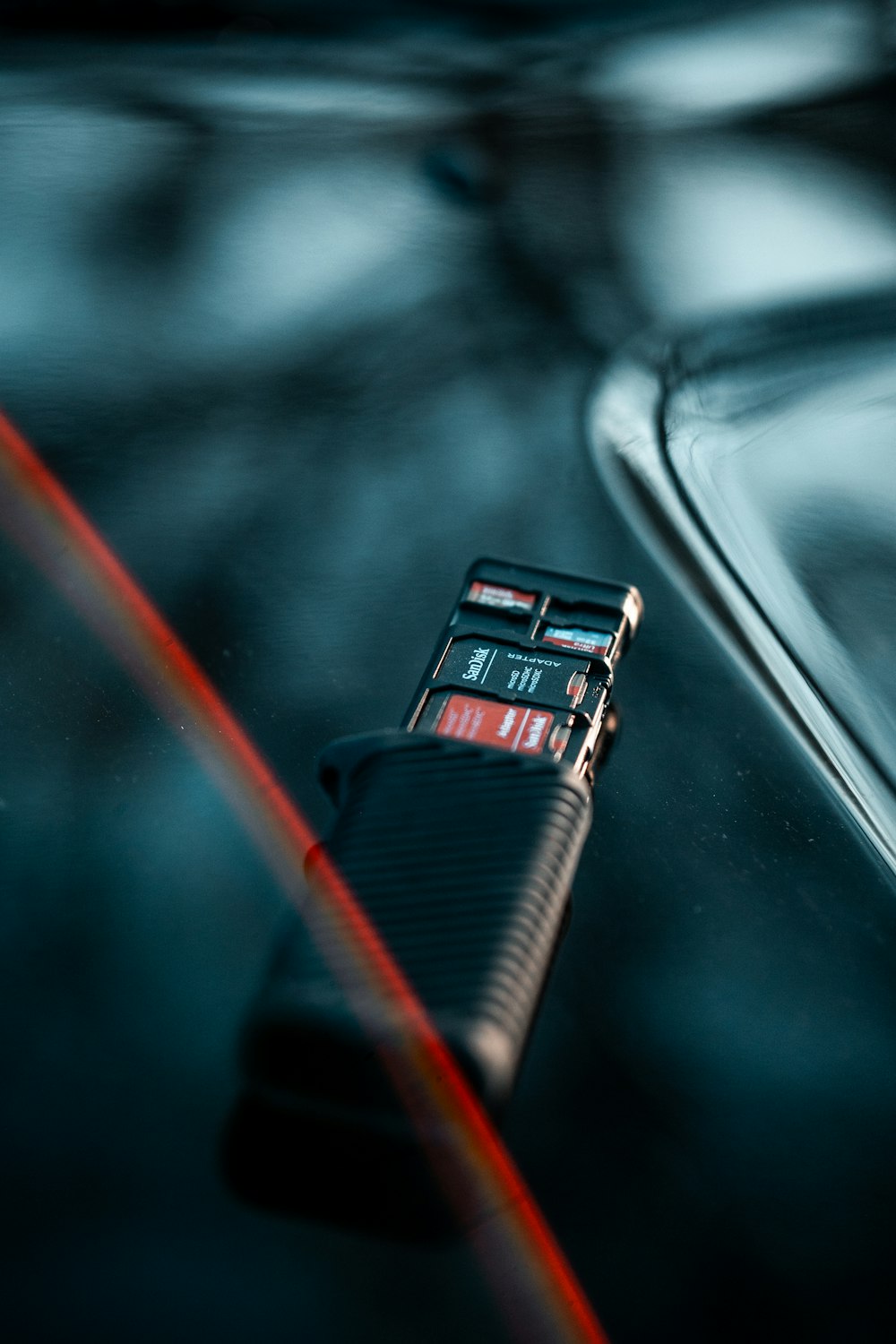 a close up of a cell phone on the hood of a car