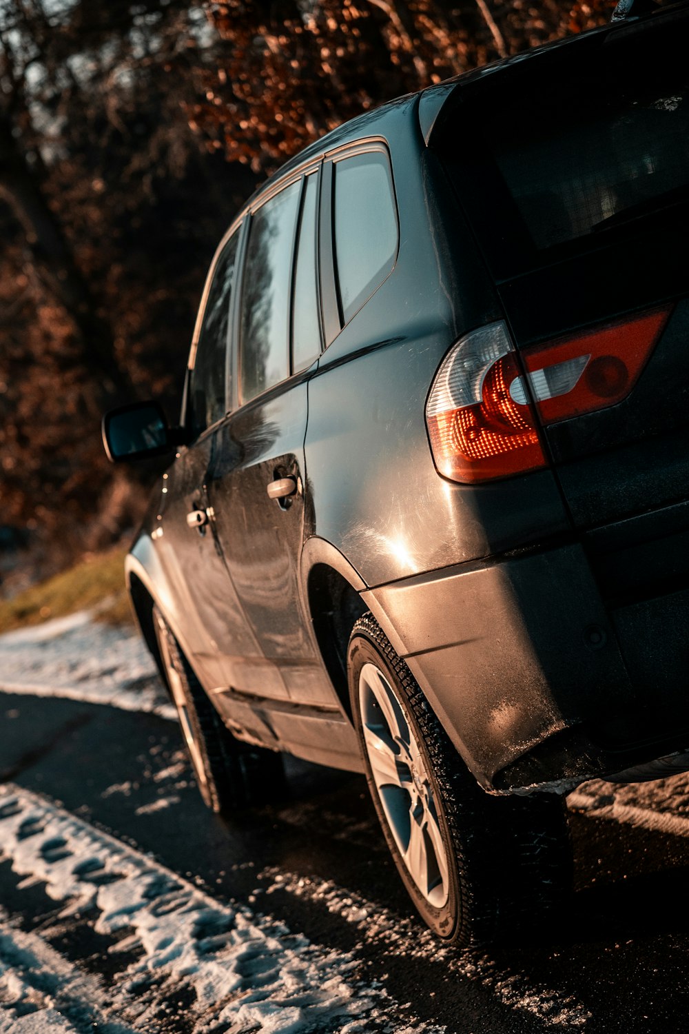 a black suv parked on the side of the road