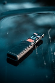 a cell phone laying on top of a car hood