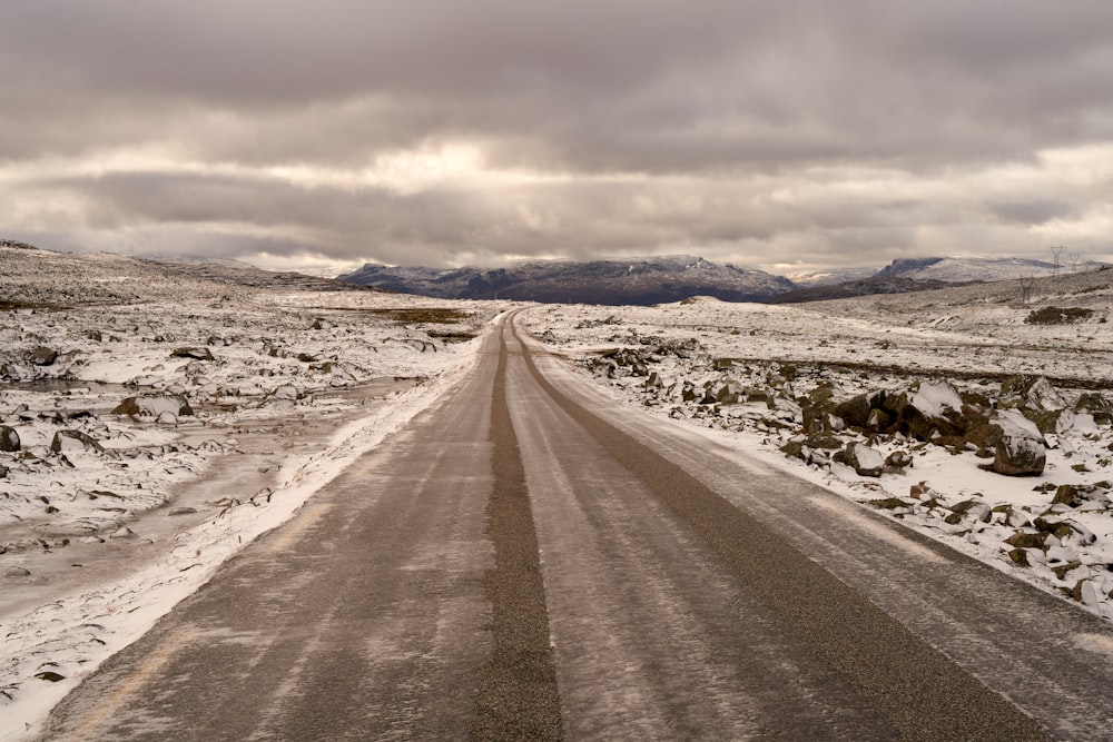 a snow covered road in the middle of nowhere