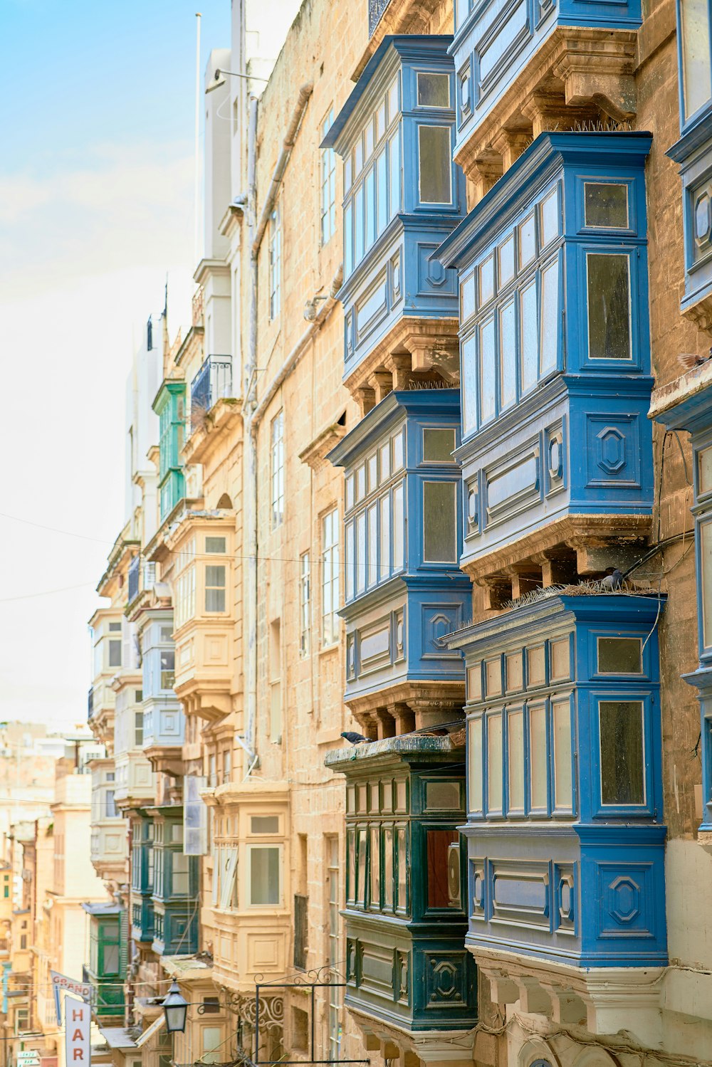 a row of buildings with blue balconies on the windows