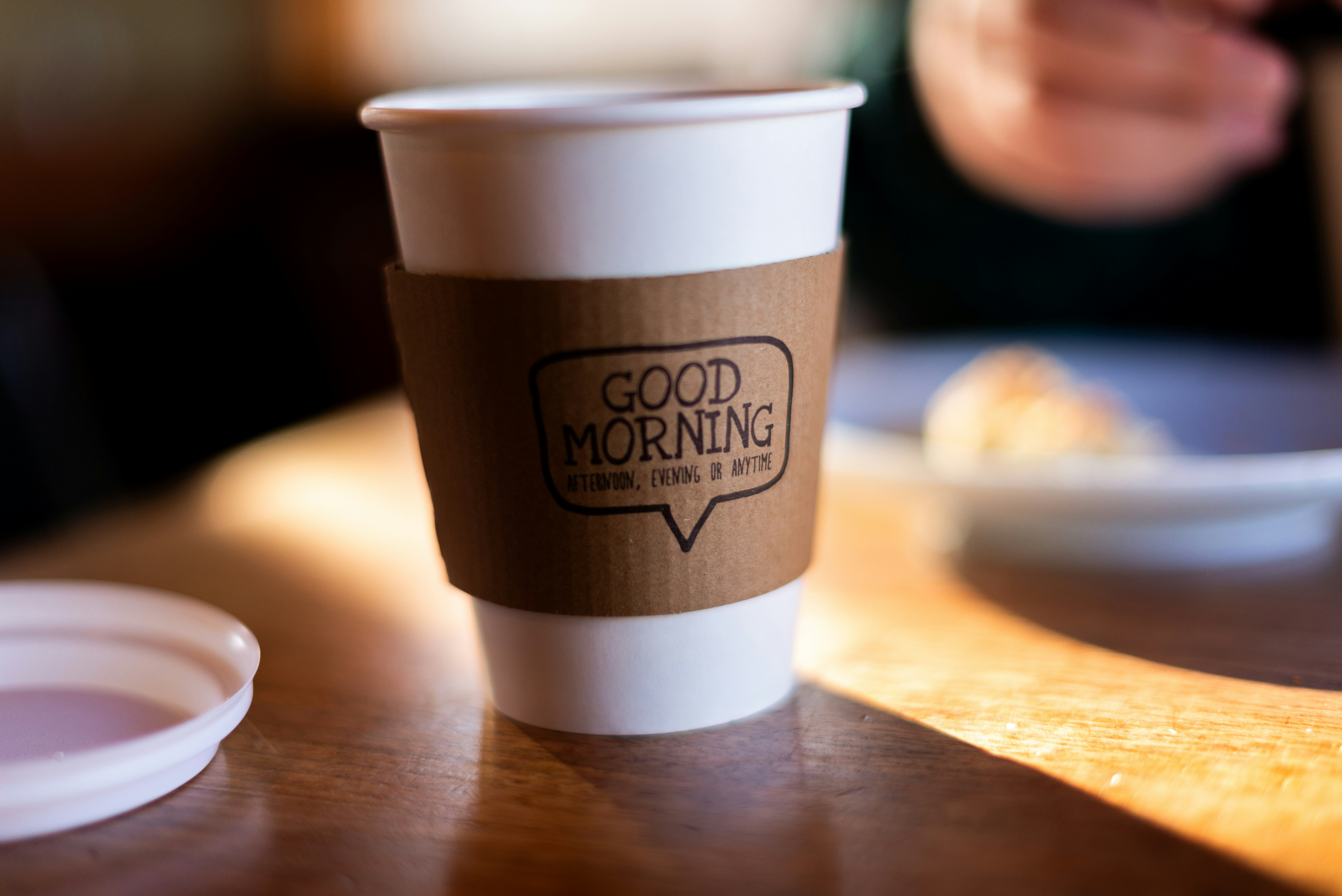 a cup of coffee sitting on top of a wooden table