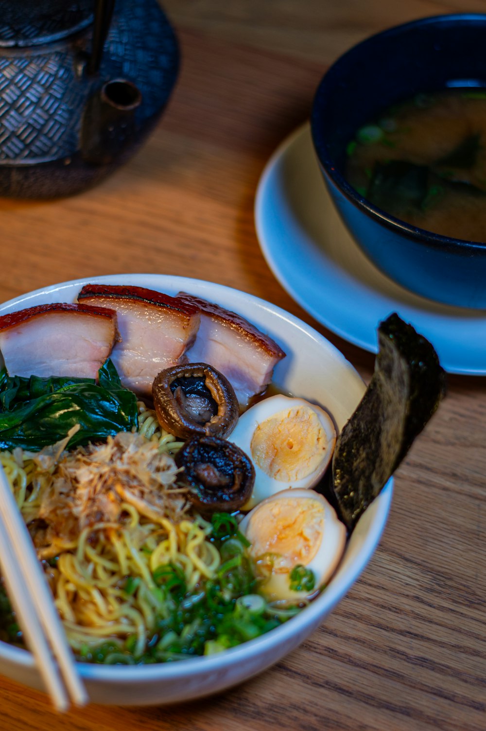 a bowl of food with chopsticks on a table