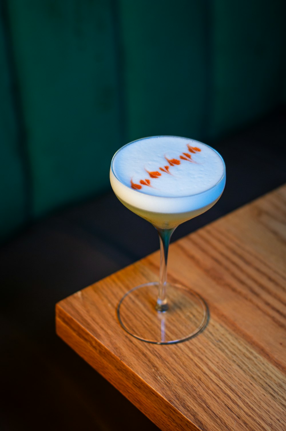 a drink sitting on top of a wooden table