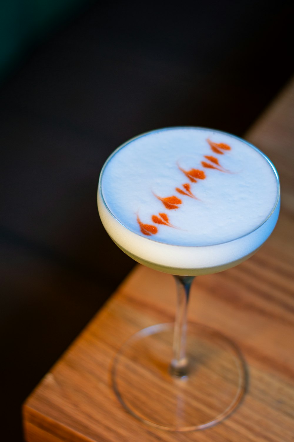 a drink sitting on top of a wooden table