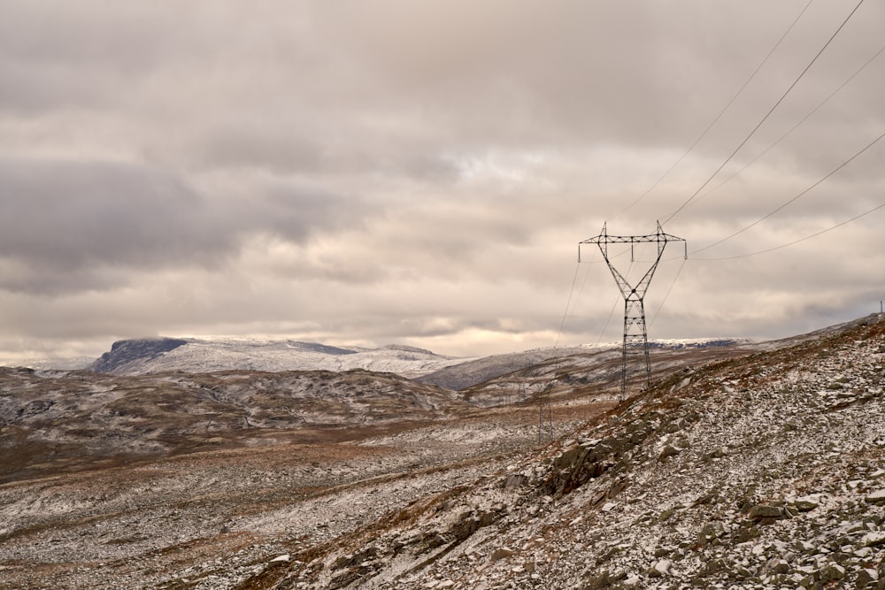 a power line on top of a rocky hill