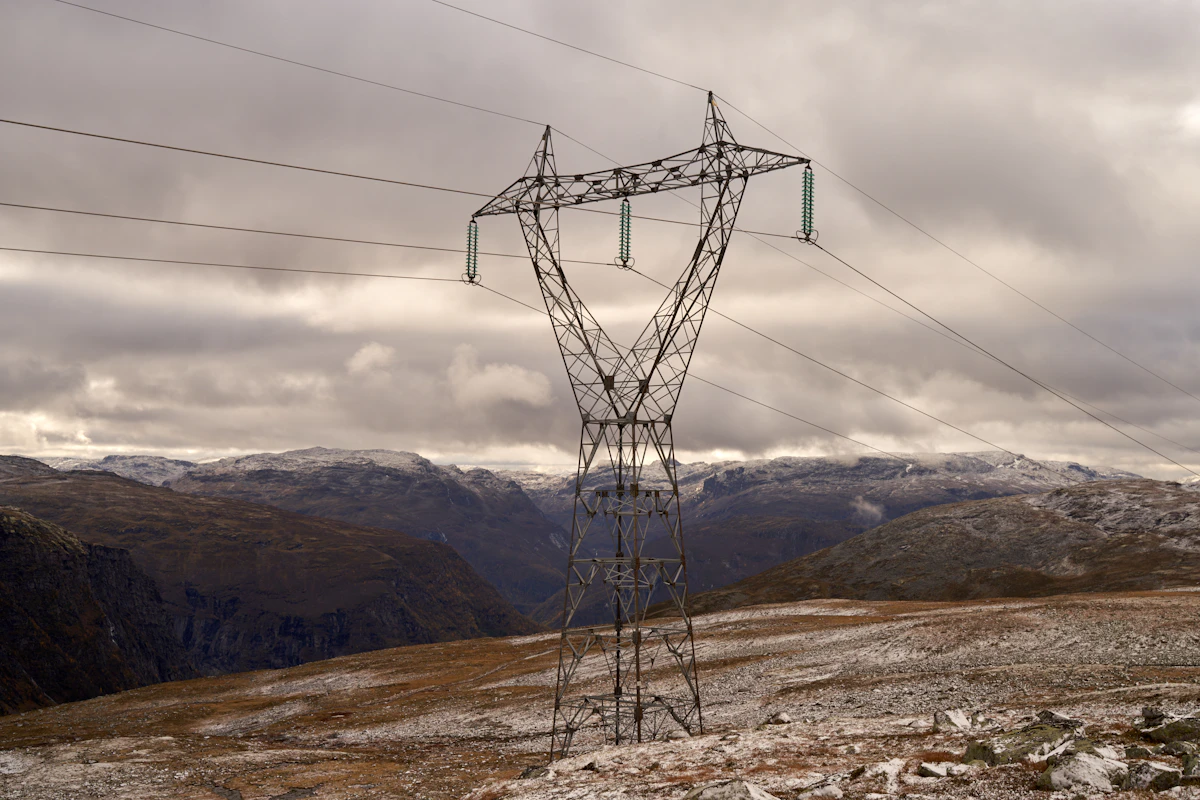 High-voltage power transmission line running through a mountain landscape