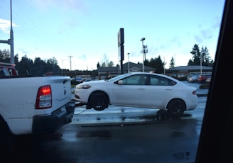 a white car being towed by a tow truck