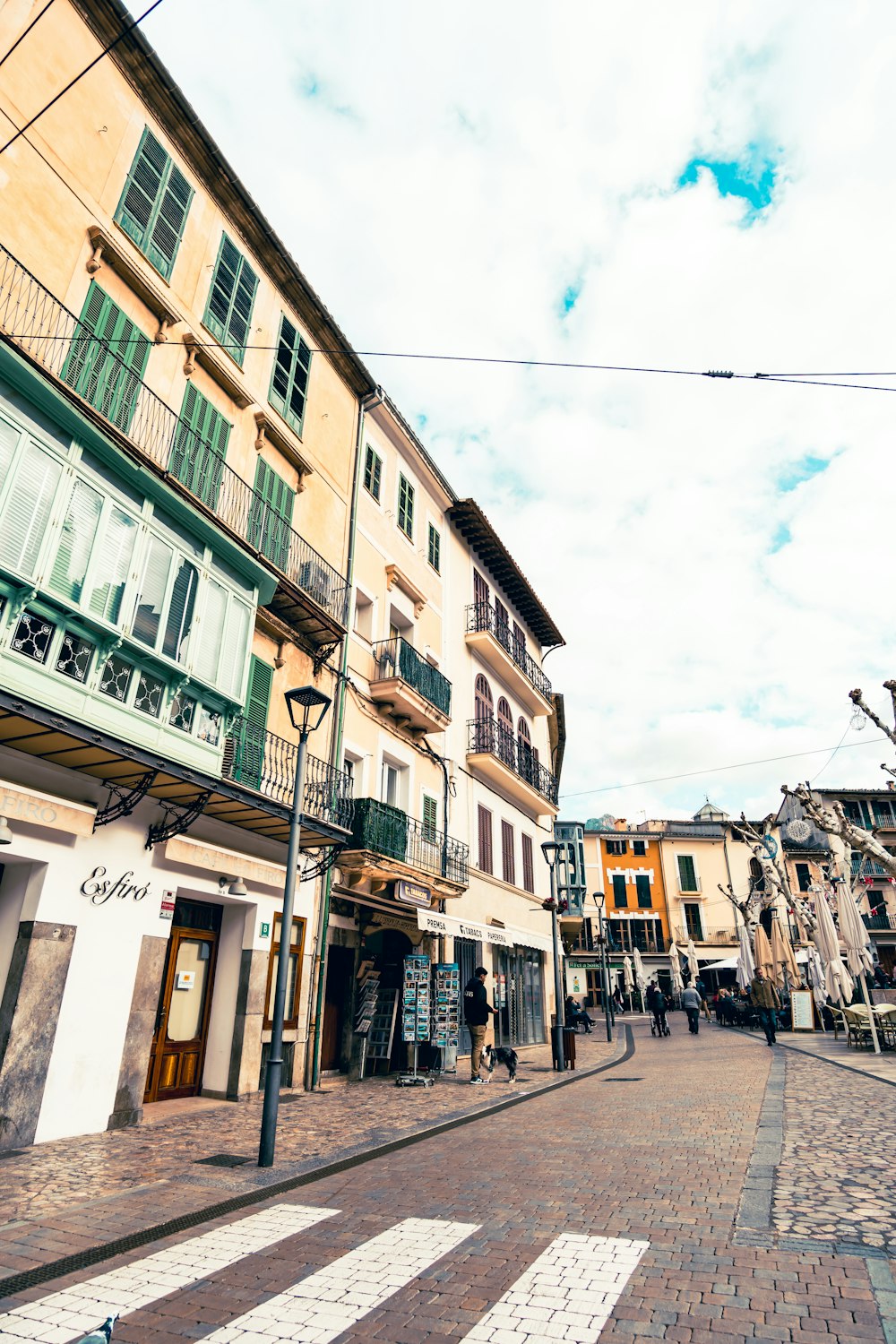 a cobblestone street lined with tall buildings