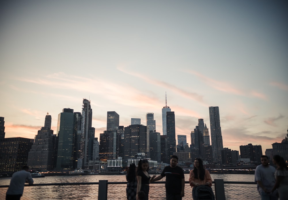 a group of people standing next to each other near a body of water