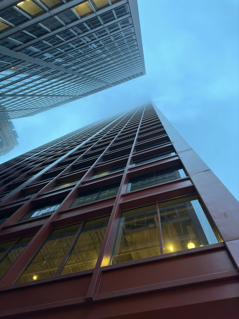 a tall red building with a sky background