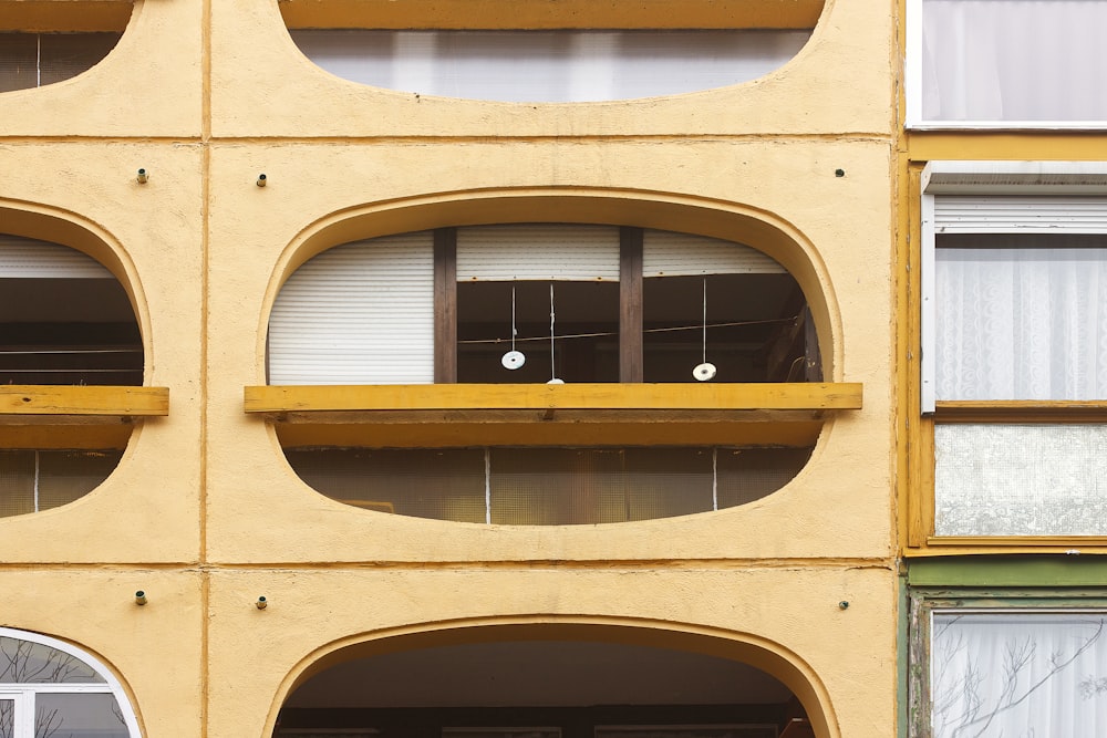 a yellow building with round windows and a clock