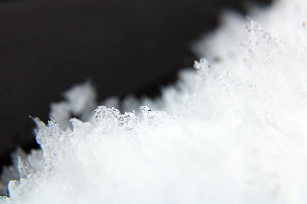 a close up of a white substance on a black surface