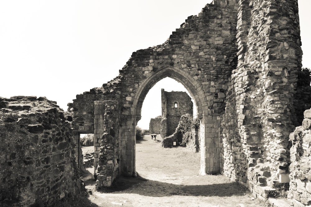 a black and white photo of a stone archway